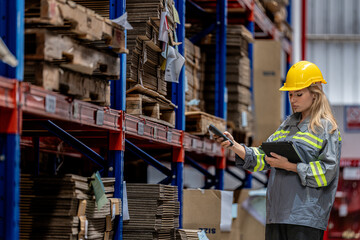 woman worker walking and checking stock items for shipping. Female inspecting the store factory....