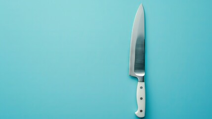A sharp kitchen knife with a white handle on a light blue background, perfect for culinary and cooking concepts.