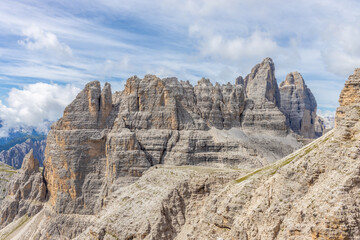 Dolomites, Alpi Dolomiti beautiful scenic mountain landscape under blue sky in summer. Rocky tower...