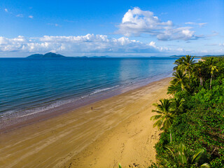 aerial drone view of the paradise beach with palms in tropical north queensland; mission beach, australia