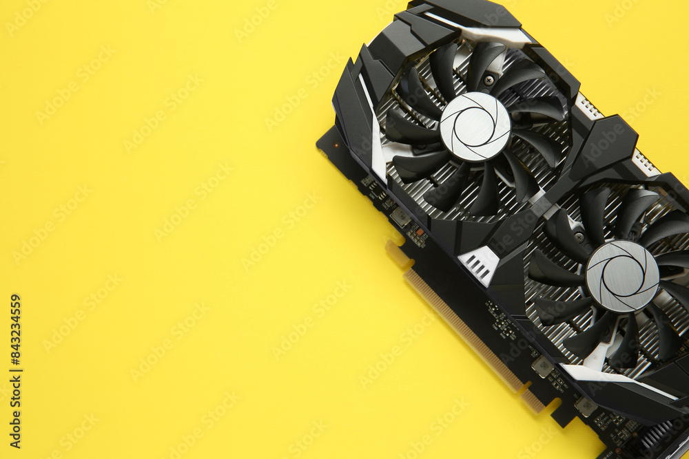 Fototapete computer graphics card on yellow background, top view. space for text