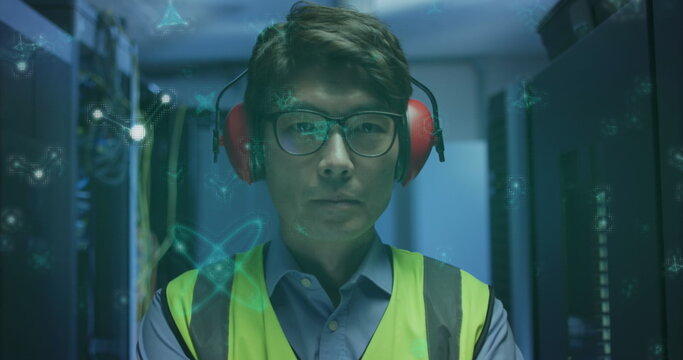 Image of molecular structures floating over asian male engineer standing at server room