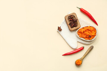 Composition with natural body scrub, spices and massage glove on color background