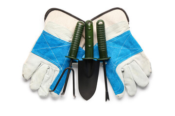 Gloves and gardening tools on white background. Top view