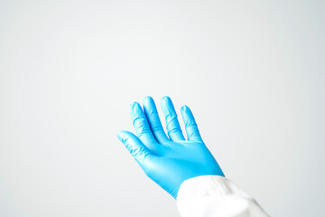 Doctor or nurse hand in sterile gloves in holding position isolated on white