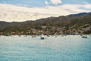 Fototapeta premium View of ocean, and boats at Avalon Harbor in Catalina Island, CA in summer from the ocean side. Sunny day
