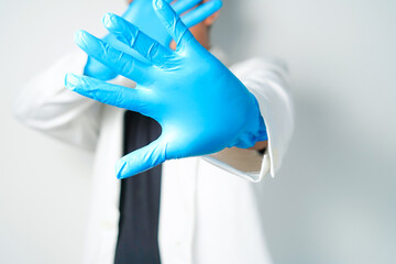 Stop gesture, arms crossed in blue gloves, sign protest, rejection, on white background