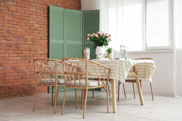 Beautiful table setting with floral decor in dining room