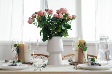 Beautiful table setting with floral decor in dining room