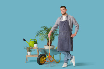 Gardening man with rake and plants on blue background