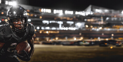 Fototapeta premium Determined Football Player in Black Uniform Holding Ball