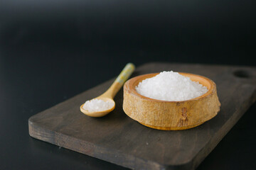 Sea salt crystals in a wooden bowl 