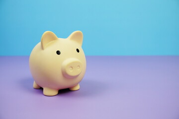 Piggy Bank Saving finance concept on blue and purple background