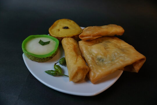 Indonesian traditional snack that called Jajanan Pasar with various color and different taste. The snack name is lumpur risol and martabak telur.