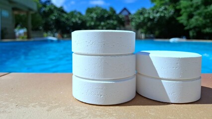 White chlorine tablets for swimming pool disinfection, pool water maintenance