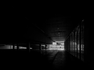 Empty parking area in a shopping mall. Black and white photo.