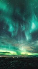 Obraz premium Northern Lights Over Snowy Mountains - Stunning capture of the Northern Lights dancing over snow-capped mountains and a calm lake, reflecting the vibrant auroras in the night sky.