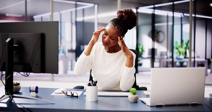 Exhausted Businesswoman Working on Computer in Office, Fighting Stress
