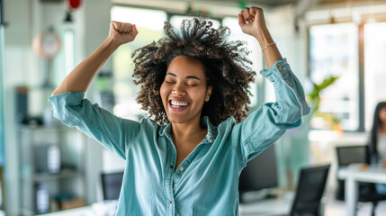 Obraz premium Excited Afro-American businesswoman at desk with hands up feel euphoric win online lottery, happy woman overjoyed get mail at laptop being promoted at work, amazed good news at computer in office
