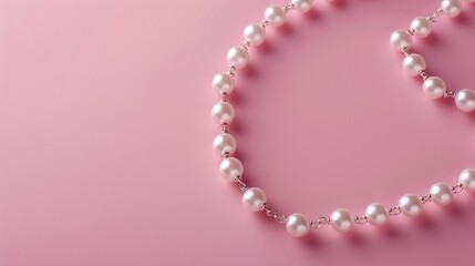 Creative necklace with pearl bead chain on soft pink backdrop