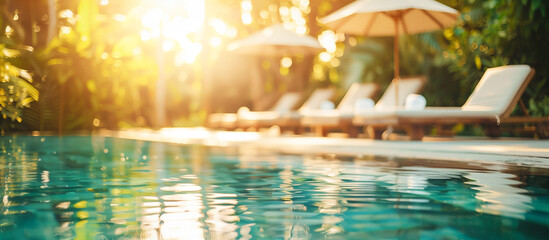 Swimming pool and sun loungers at tropical summer hotel 
