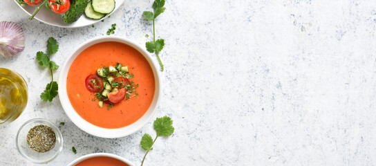 Gazpacho soup in bowl over light stone background with free text space