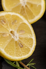 slices of sour lemon on a black board
