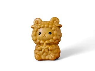 Miniature wooden sheep holding a star on a white background