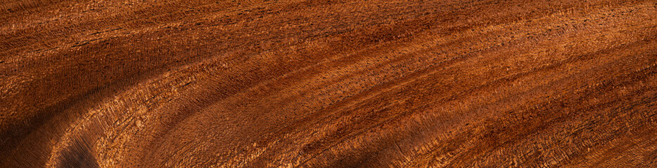 Close-up of mahogany feathered wood, a luxurious surface with rich, intricate patterns
