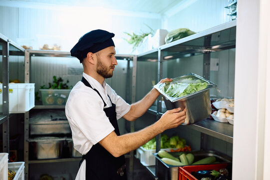 Chef taking fresh groceries from  pantry room.