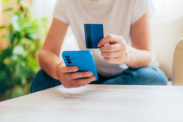 Person Using Mobile Phone and Credit Card for Digital Payment