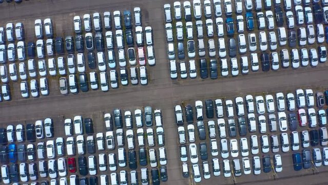 Aerial.new car storage parking lot showing imported new vehicles or ready to export new automobiles storage facility. 