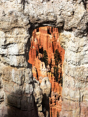 Looking through a light colored arch at the bizarre hoodoos of Bryce Canyon in Utah