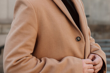 Fashion details of street style cloth beige brown men's coat. Classy urban outerwear