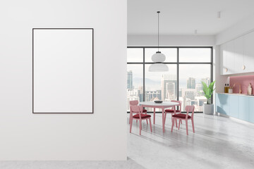 Framed poster mockup on a white wall next to a modern dining area with city view. Bright kitchen...