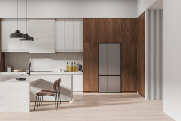 Beige home kitchen interior with bar table and cabinet, modern appliances