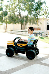 Little boy playing electric car. Learning Concept. Copy space. Selective focus.