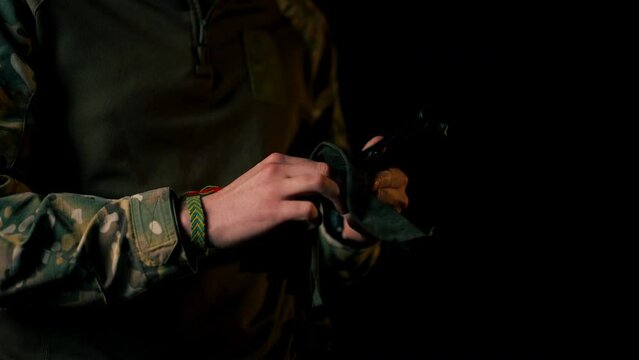 close up in a professional shooting range professional fighter parts cleans pistol introductory briefing
