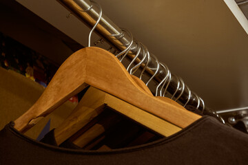 Black t-shirts on wooden cloth hangers.