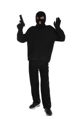 Emotional thief in balaclava with gun raising hands on white background