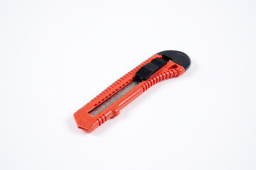red utility knife on white background