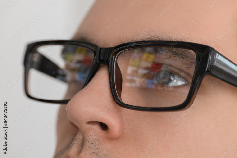 Wall mural Man wearing glasses on light background, closeup