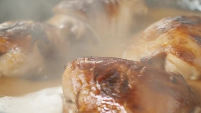 roasted chicken served with a mouthwatering gravy, Closeup of a pan filled with sizzling organic chicken, chicken broast, made with Ai generative technology, stock video 4K Clip