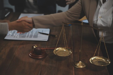 Judge gavel with Justice lawyers having team meeting at law firm background. Concepts of Law and Legal services.