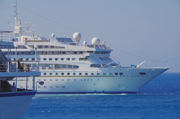 Naklejka premium Classic ocean cruiseship cruise ship liner Nefeli in port of Rhodes City, Greece with panoramic oceanscape sea views and other passenger vessels in harbor