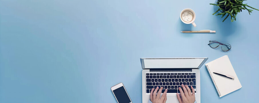 a person typing on an iPhone with a laptop and office accessories in front of a solid blue background. Web banner with copy space on the right