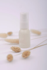 Unlabeled bottle of cosmetic or soap shower gel is displayed on an artistic background, product enclosure for liquid product for promotional