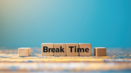Wooden blocks with the words Break Time on a blue background Symbolizing a concept with space for copying