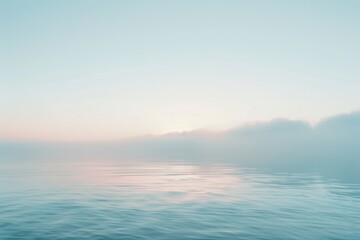 Fototapeta premium Tranquil ocean scene with a hazy horizon and gentle light, ideal for peaceful and minimalist themes.