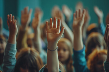 group of children with their hands up to answer a question or ask for something.